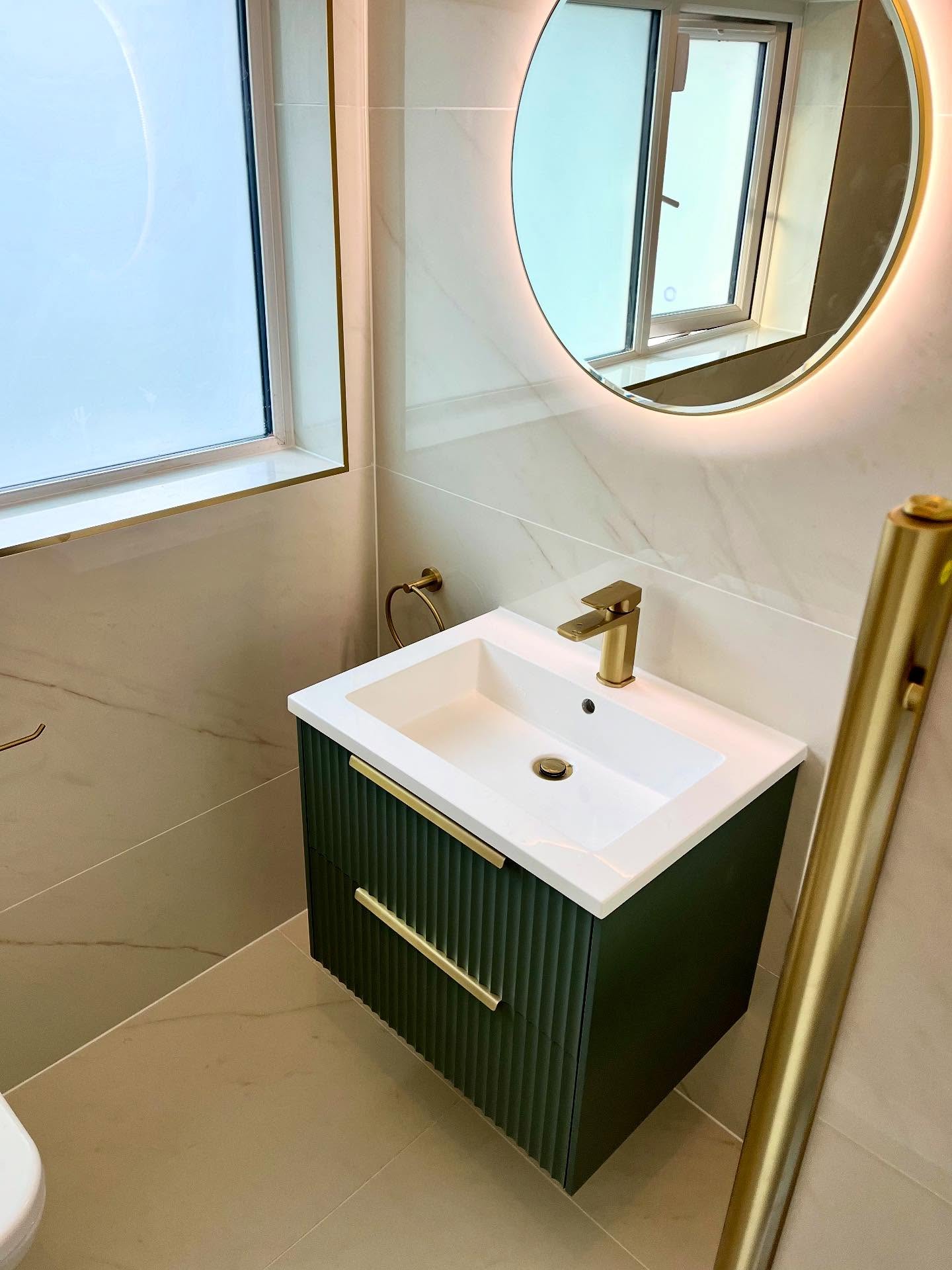Bathroom with white subway tiles, freestanding bath and black-framed shower enclosure